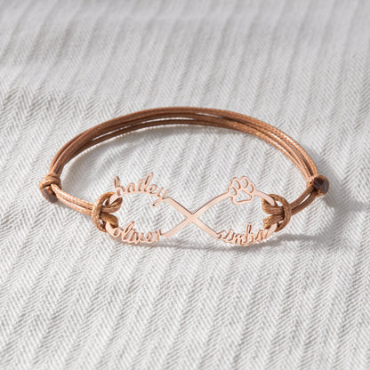 Green Millie custom pet name bracelet with engraved dog and cat motifs, designed as a heartfelt pet memorial bracelet.