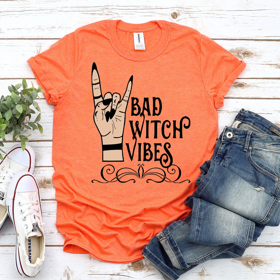 Black Halloween T-shirt by Agate featuring "Bad Witch Vibes" graphic design with spooky, witch-themed artwork.