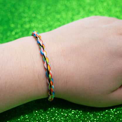 Handmade cotton bisexual friendship bracelet featuring colorful LGBTQ pride symbols, designed by Rose Erebus.