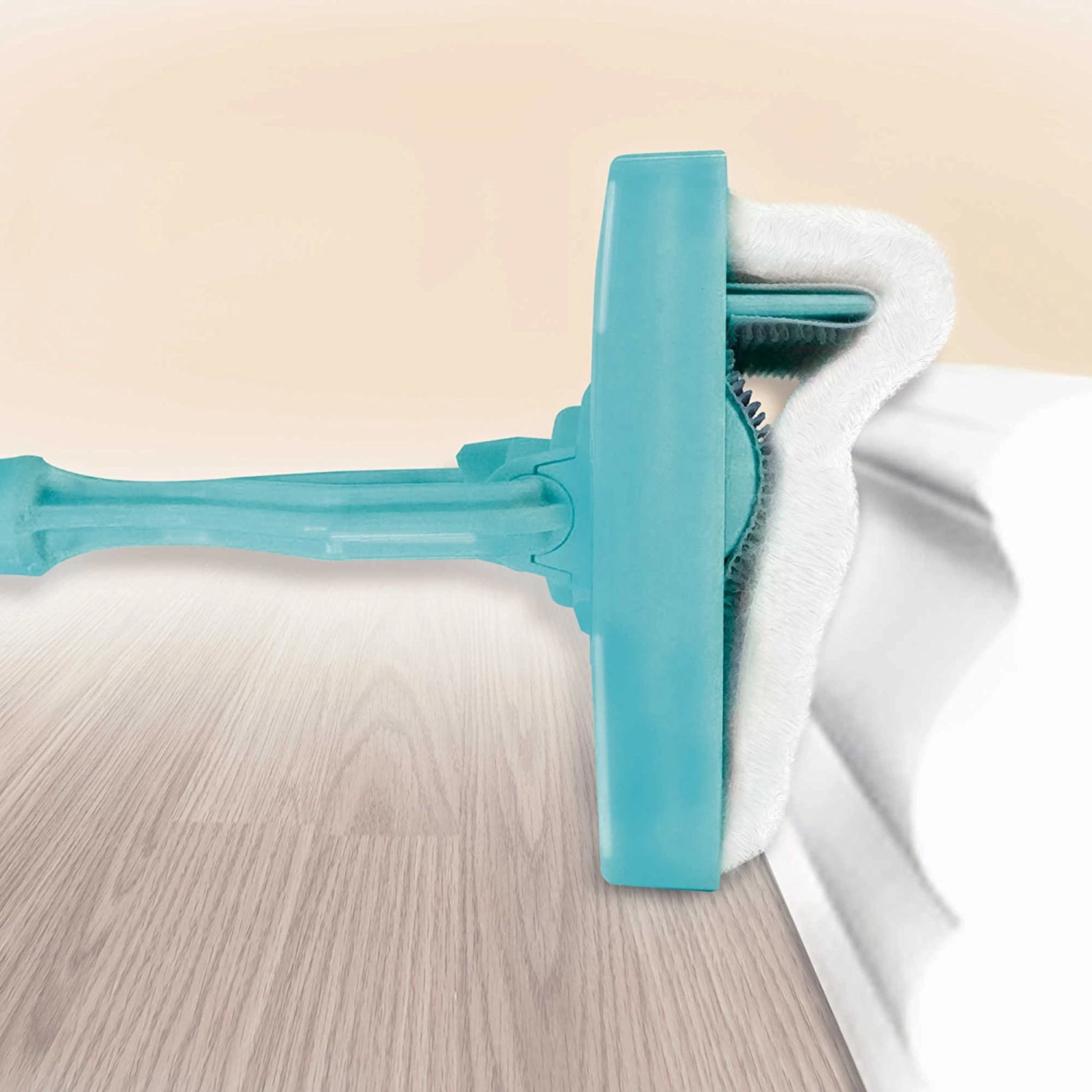 Teal Simba Baseboard Buddy retractable cleaning brush mop for household baseboard and surface cleaning in home and garden.