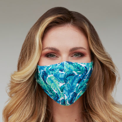 Cyan Poppy tropical banana leaves face mask for women with vibrant leafy pattern and comfortable fabric design.
