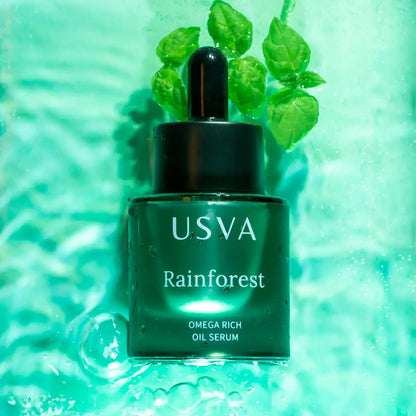 Lilac Lavender Rainforest Omega Rich Oil Serum in a glass bottle, featuring a dropper for skincare use.