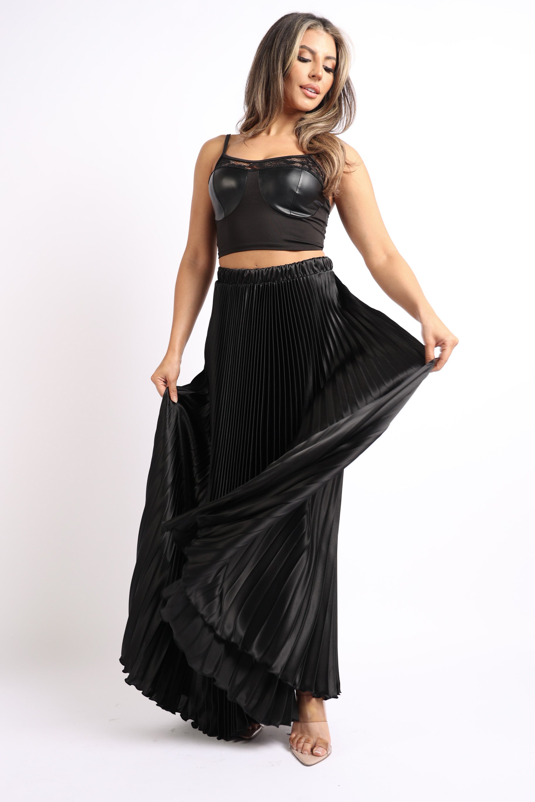 Black satin maxi skirt with elastic high waist, A-line silhouette, and pleated design by Puce Juniper.
