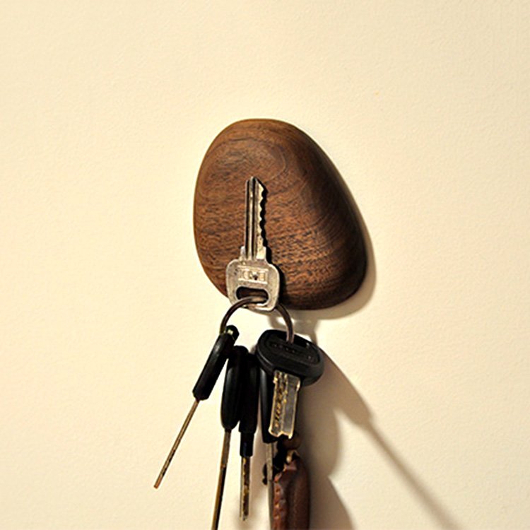 Walnut magnet key holder from Fuchsia Molly, mounted on a wall with hooks for organizing keys in a stylish home decor setting.