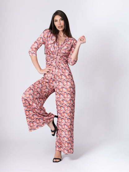 Fuchsia Amymone printed jumpsuit with V-neck, front knot detail, and elastic waist, perfect for casual and stylish looks.