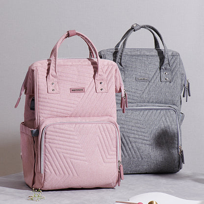 Maroon Chronos quilted diaper baby backpack with multiple compartments, padded shoulder straps, and baby care accessories visible.