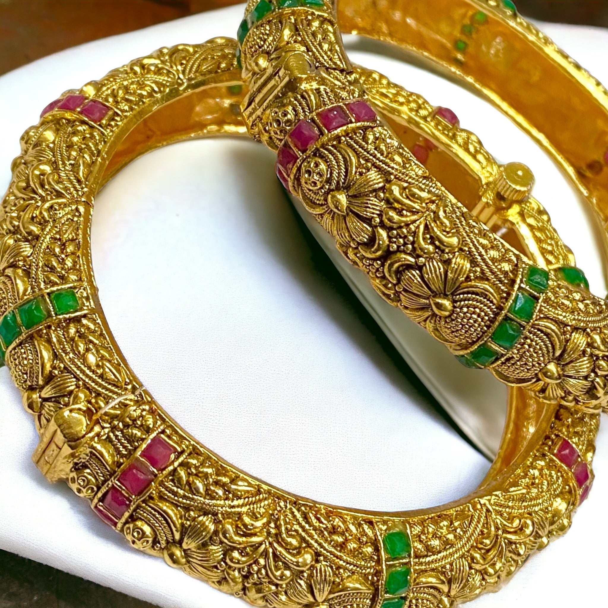 Gold-plated traditional bangles from Gray Poseidon, featuring intricate designs on elegant bracelet-style jewelry.