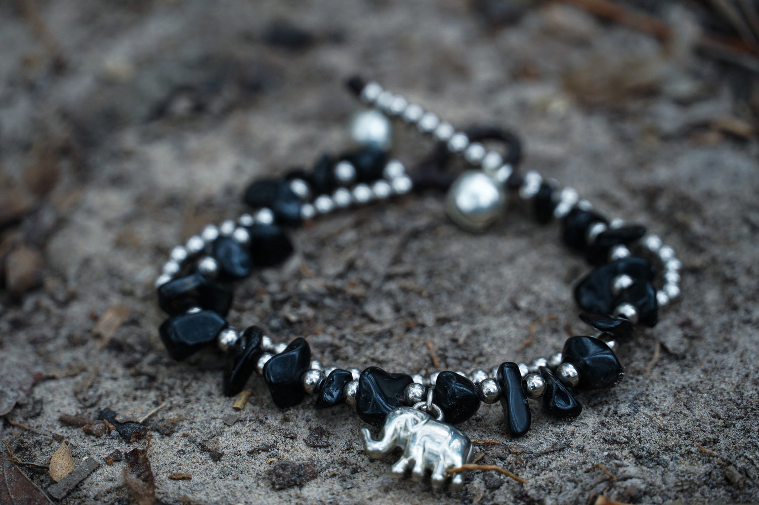 Silver stone Boho elephant bracelets by Tan Smokey featuring intricate elephant charms and beaded design.