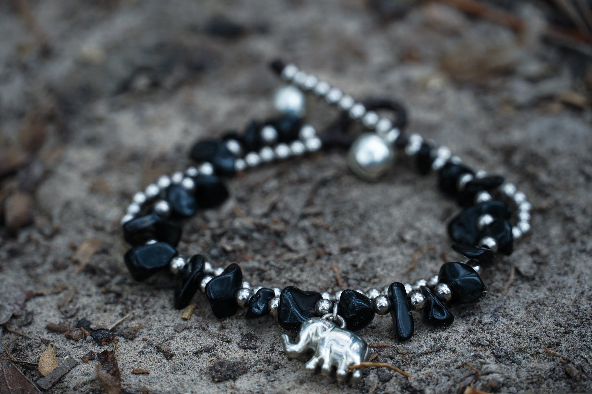 Silver stone Boho elephant bracelets by Tan Smokey featuring intricate elephant charms and beaded design.