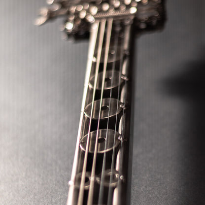 Metal electric guitar sculpture wall art by Turquoise Poppy, with a heavy metal design for modern home decor.
