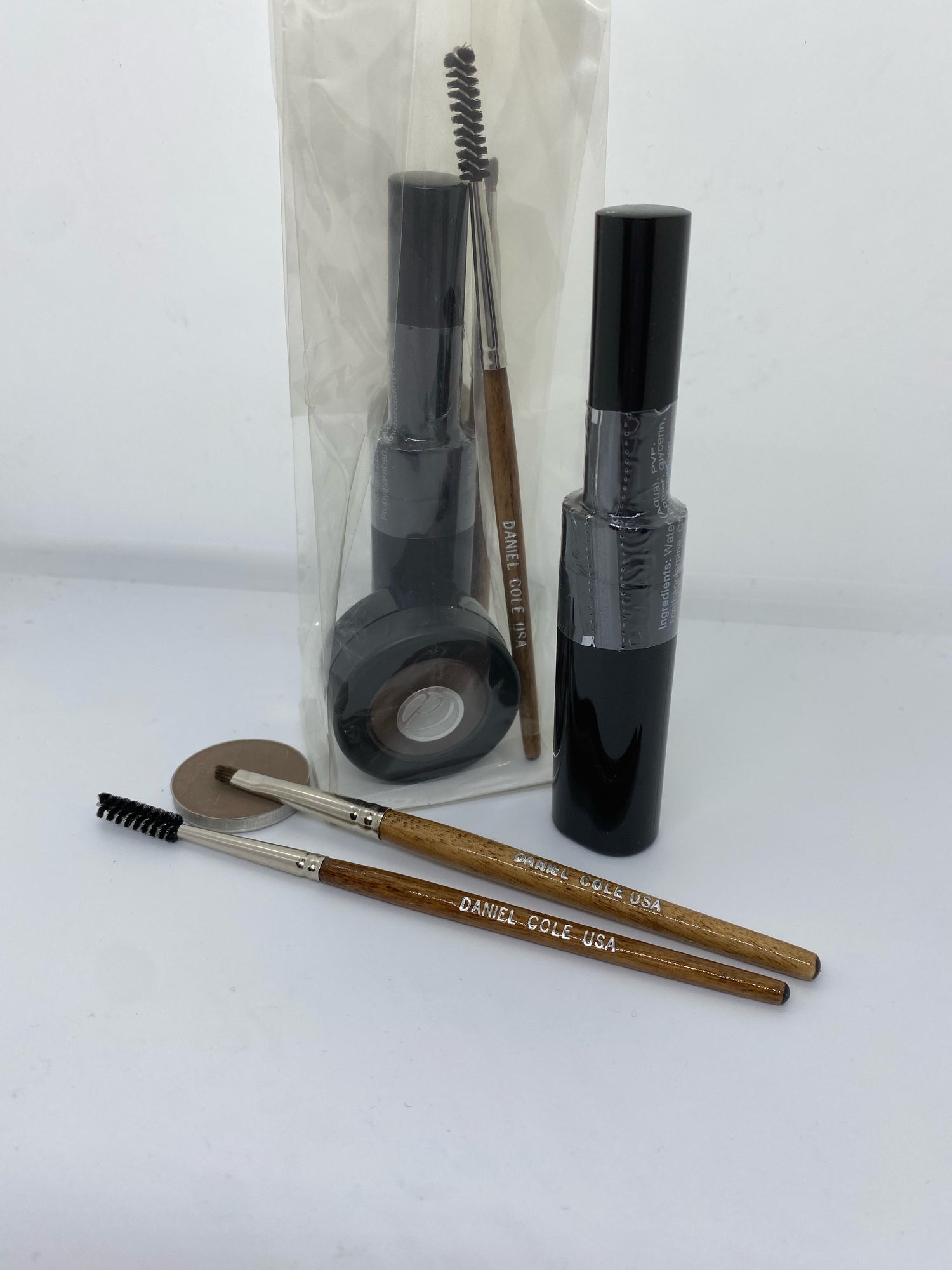 Carmine Ariadne Ultimate Brow Kit with eyebrow pencils, powders, and brushes for defined, natural-looking brows.