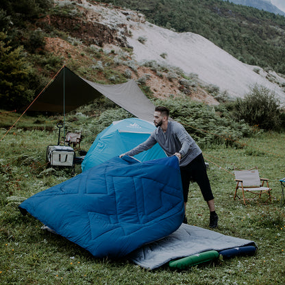 Indigo Eurybia Camfy 50 camping sleeping bag laid out outdoors, showing its insulated, lightweight design for outdoor sleep comfort.