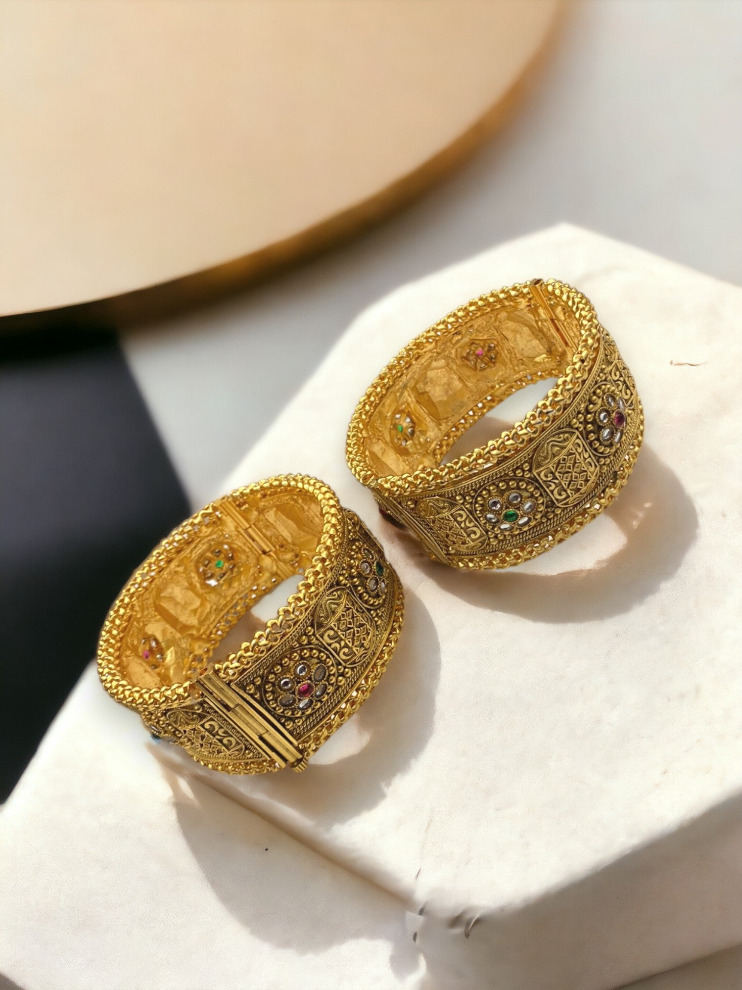 Gold-plated Indian bangle bracelets by Gray Poseidon featuring intricate traditional and modern design elements.