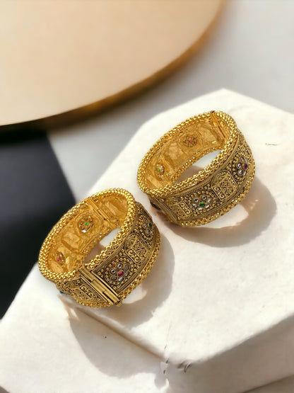 Gold-plated Indian bangle bracelets by Gray Poseidon featuring intricate traditional and modern design elements.