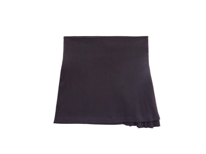 Emerald Hephaestus half-pleated mini skirt shown on a model, featuring a stylish, short skirt with pleats for a trendy look.