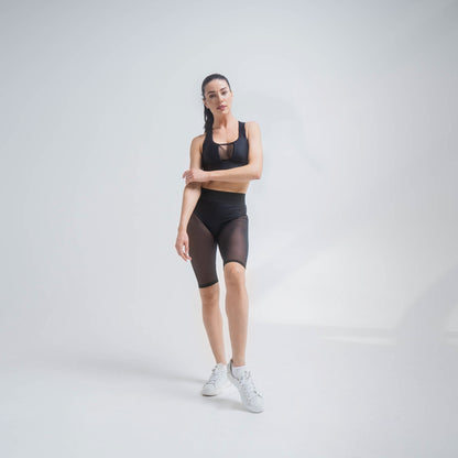 Black mesh shorts by Indigo Thalassa, featuring lightweight breathable fabric and a comfortable fit for casual wear.