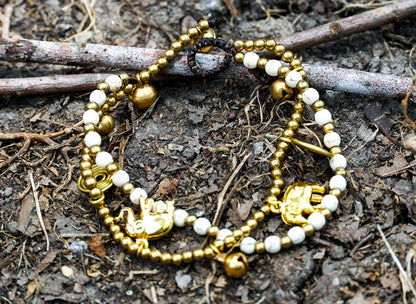Tan Smokey boho brass elephant bracelets featuring intricate elephant charms and adjustable band for stylish wristwear.
