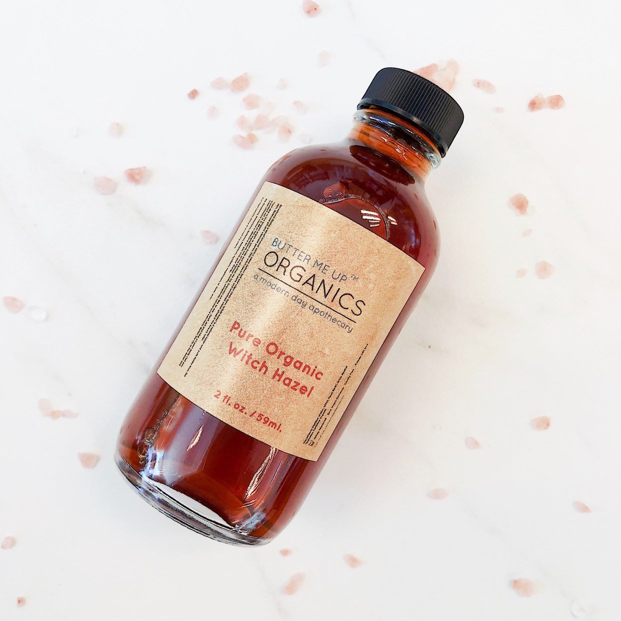 White Smokey Organic Witch Hazel facial toner in a clear bottle with a white cap, designed for skincare and facial refreshing.