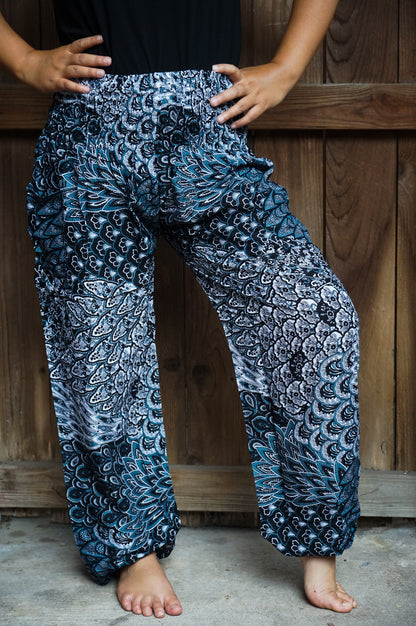 Black peacock print boho yoga pants for women, hippie style Tan Smokey pants with relaxed fit and comfortable design.