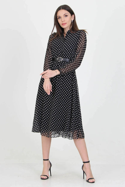 Black polka dot dress by Aquamarine Felix featuring a fitted bodice and flowing skirt, perfect for casual or semi-formal occasions.