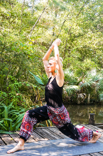 Black floral harem pants for women by Tan Smokey featuring boho and hippie style with flowing, relaxed fit.