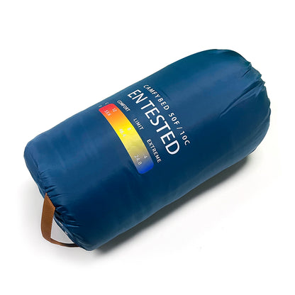 Indigo Eurybia Camfy 50 sleeping bag for camping, shown in outdoor setting with adjustable straps and cozy insulation