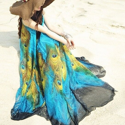 Yellow Pandora sleeveless peacock-themed long dress with vibrant peacock feather patterns and flowing fabric.