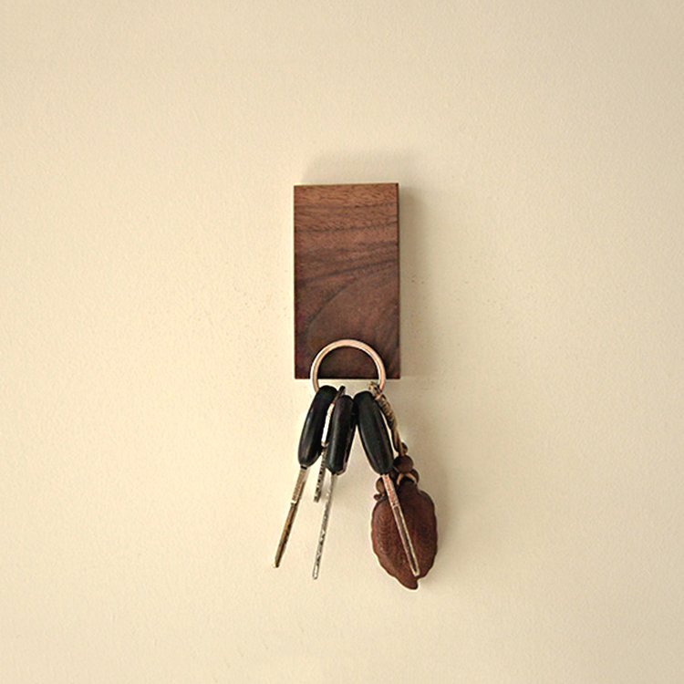 Walnut Fuchsia Molly magnet key holder mounted on a wall, with multiple hooks for organizing keys in a home and garden setting.