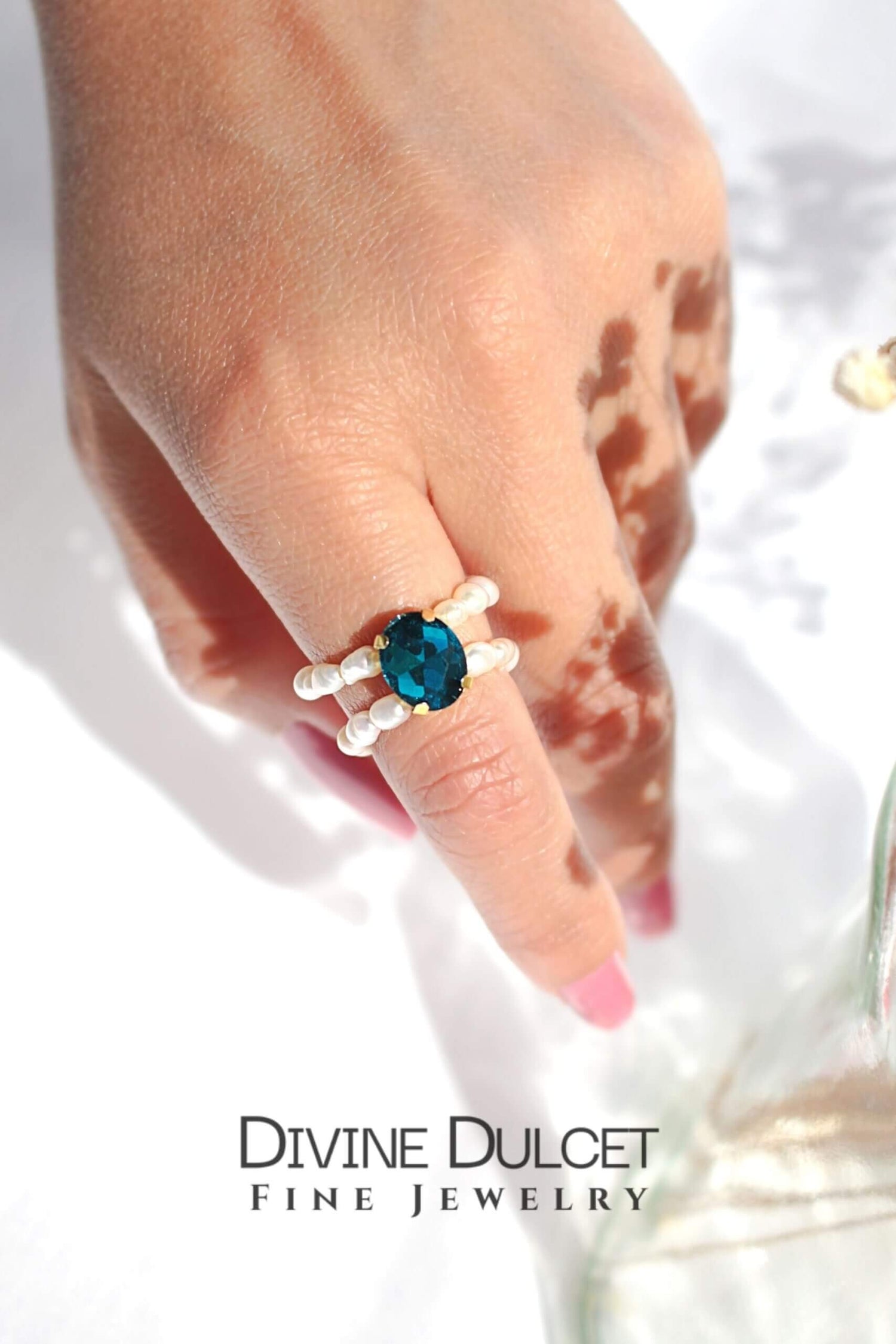 Ultramarine Birch blue CZ and freshwater pearl rings in three shades, showcasing elegant jewelry with sparkling stones and pearl accents.