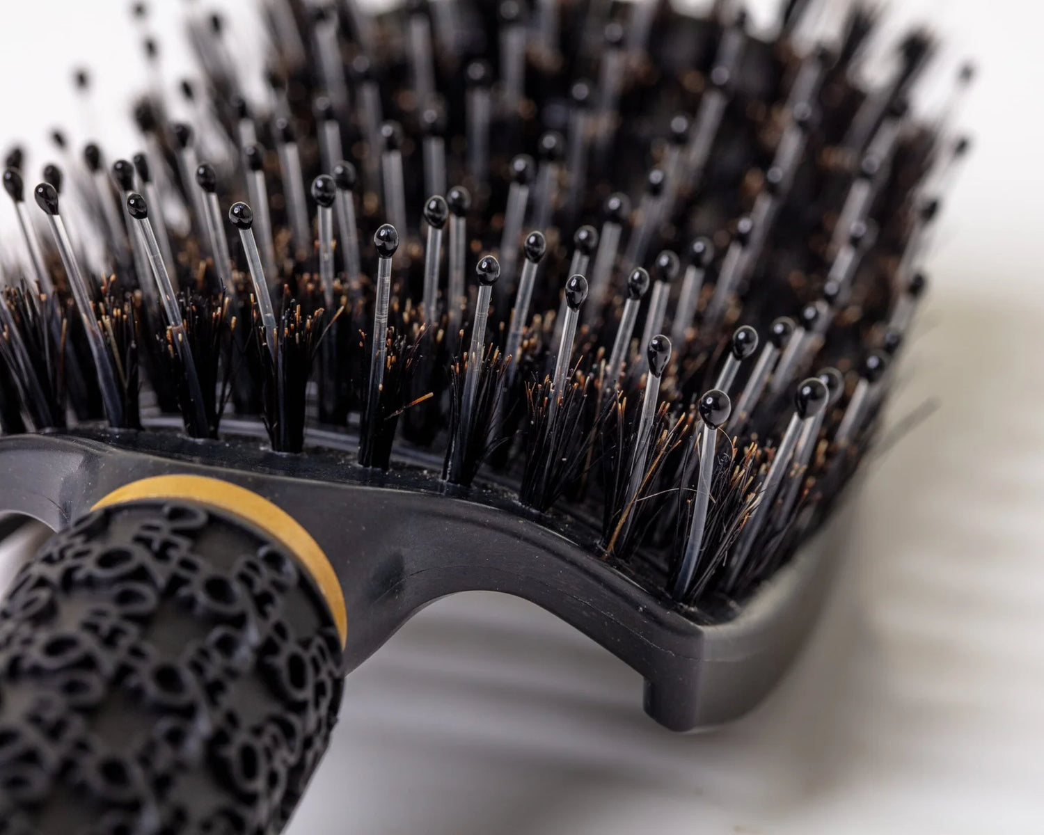 Black Burgundy Clover hair comb with wide teeth, ideal for detangling and styling hair.