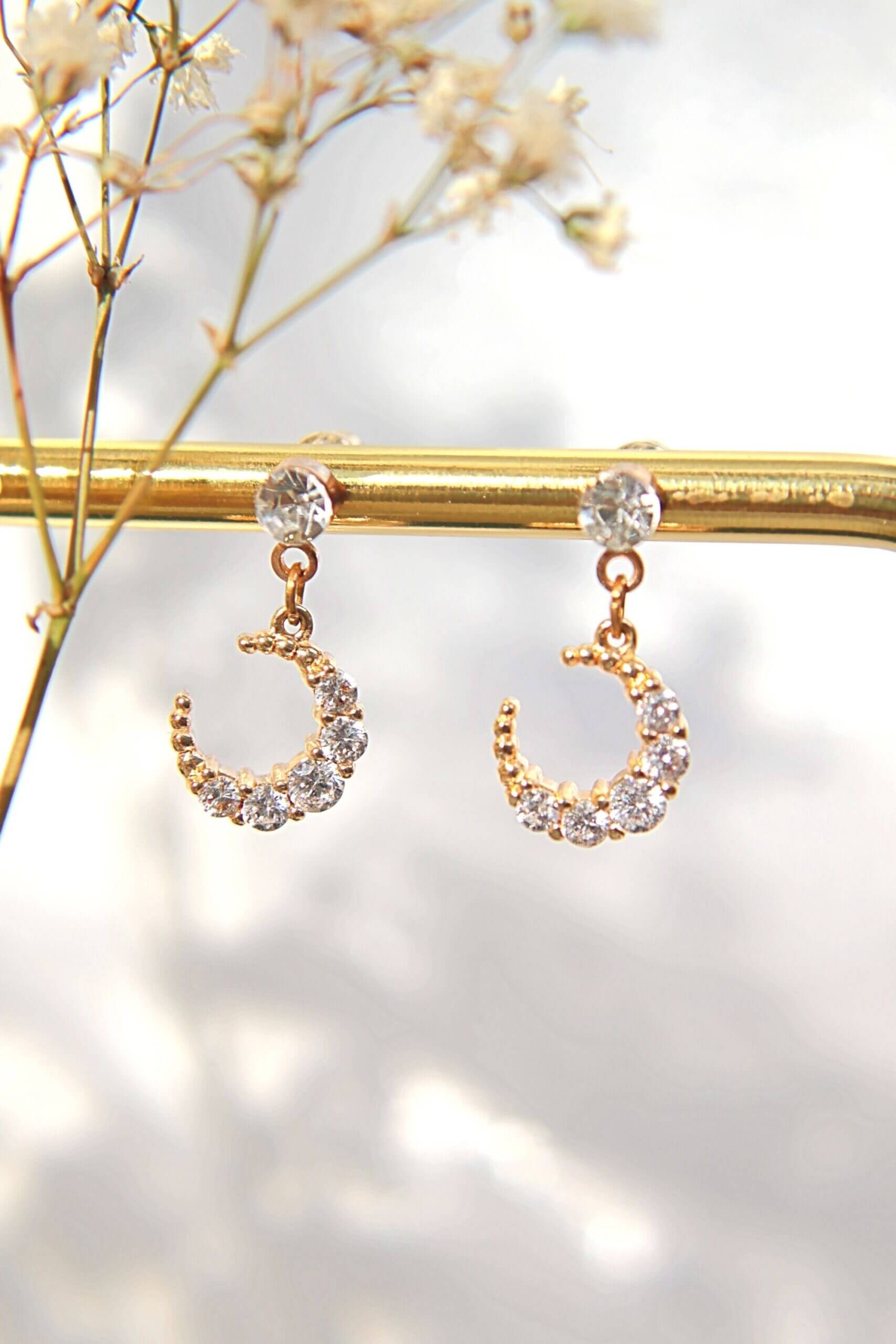 Ultramarine Birch 24 Karat Moon Cubic Zirconia Stud Earrings featuring shimmering moon-shaped zirconia gemstones on silver posts.