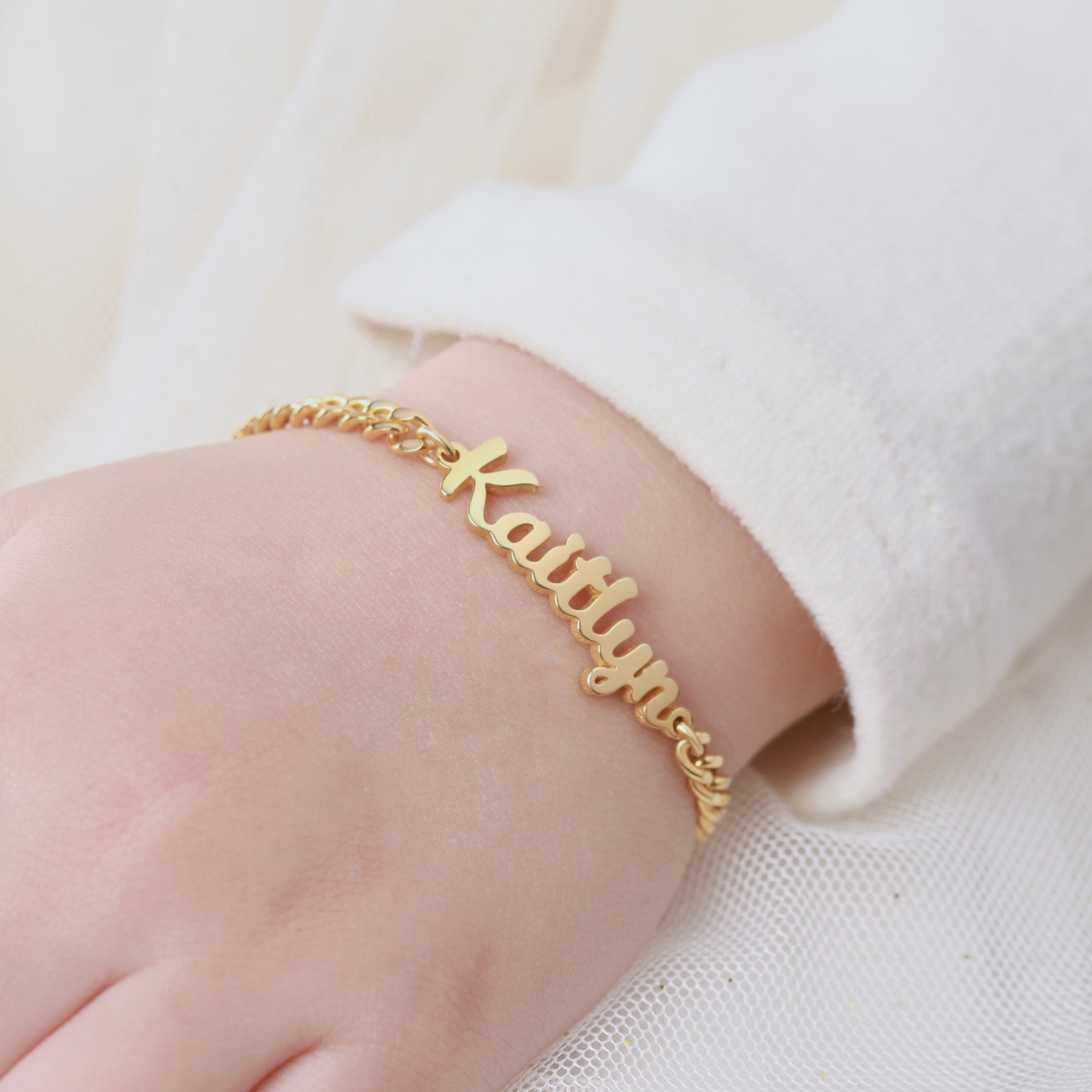 Green Millie child name bracelet featuring a delicate design, perfect for little girls, with personalized baby name jewelry.