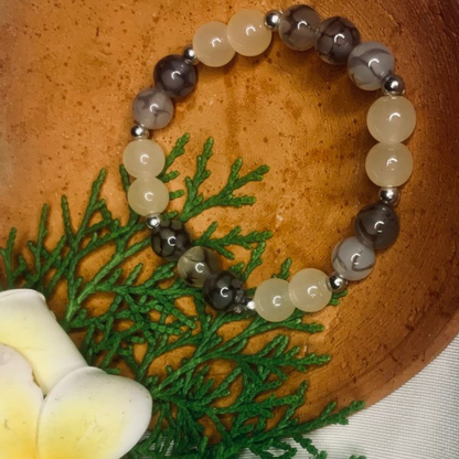 Gray and white agate gemstone beaded bracelet with silver spacers, crafted by Tan Saffron, showcasing elegant natural stone beads.