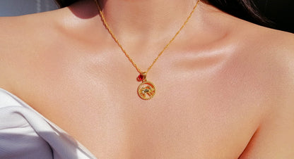 Ultramarine Birch 18K zodiac sign and birthstone necklace featuring a gold pendant with zodiac symbol and colorful birthstone.