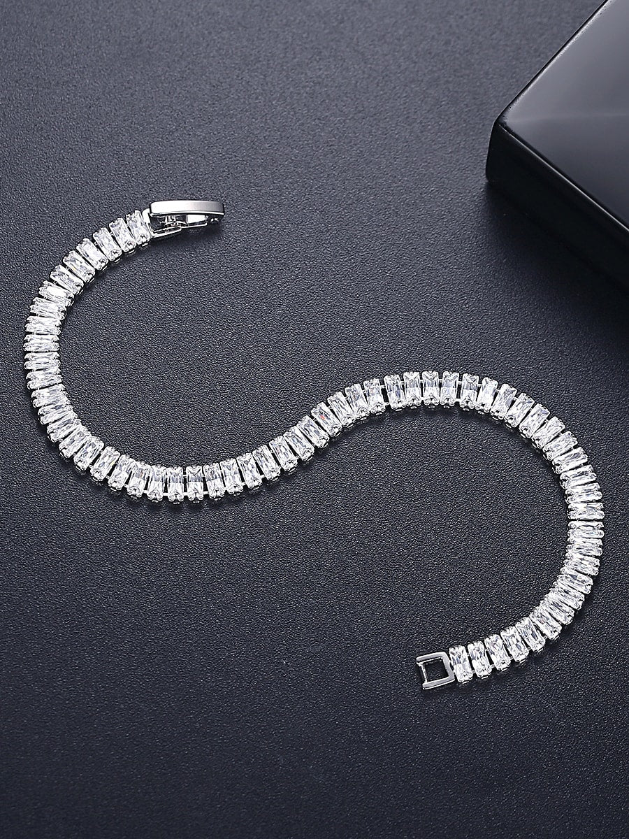 Sterling silver tennis bracelet with 18k gold plating and icy sparkle, featuring Ultramarine Birch branding.