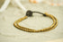 Golden double strand boho brass bracelet with hippie style, featuring intricate design and adjustable clasp, by Tan Smokey.