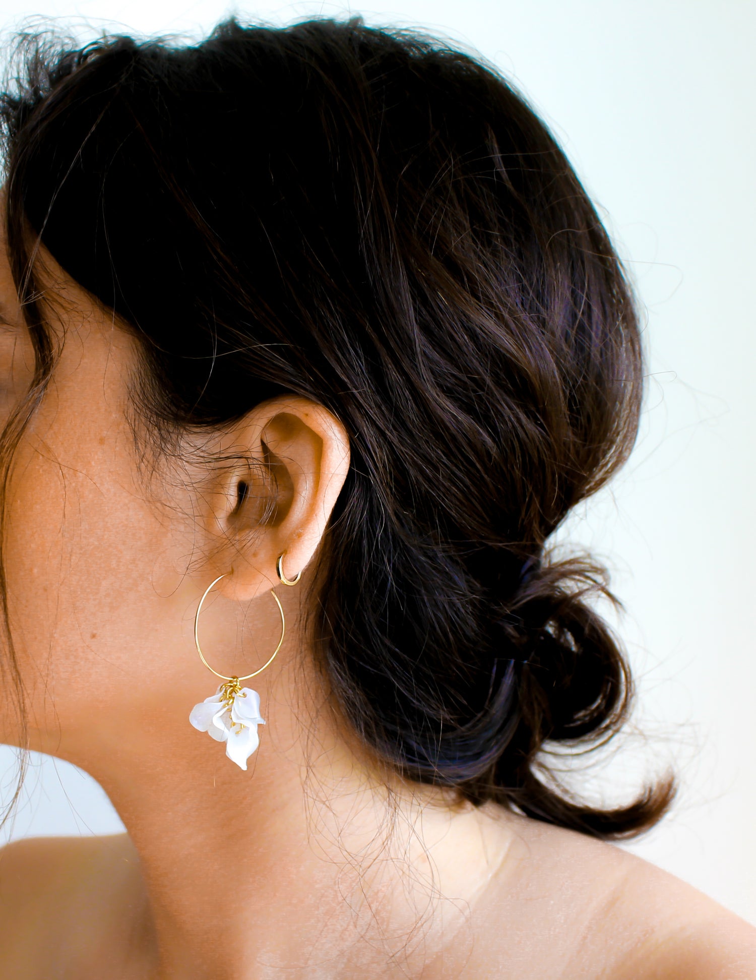 Indigo Jocasta Vita earrings featuring elegant gold-tone drop earrings with intricate design details.