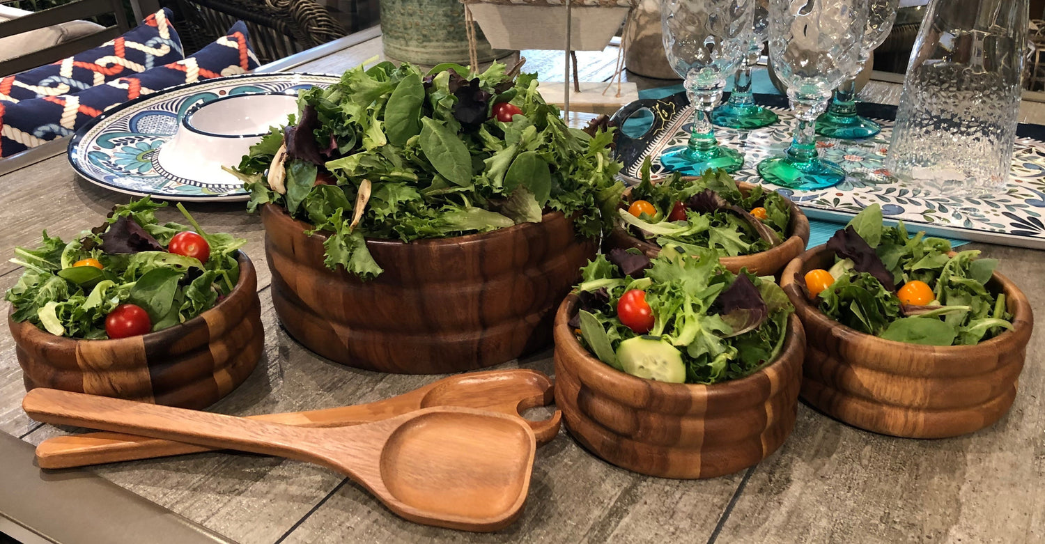 Azure Lily 7-piece extra large salad bowl set with servers, shown with four individuals enjoying a salad outdoors.