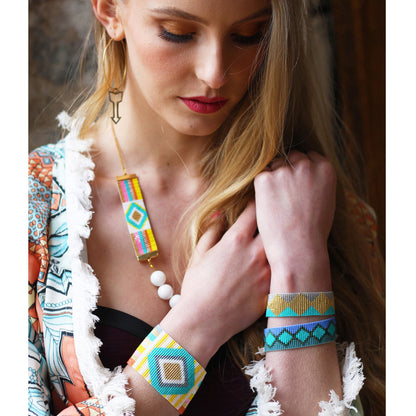 Yellow Athena Soleil Bracelets featuring colorful beaded designs and adjustable closures on a neutral background.