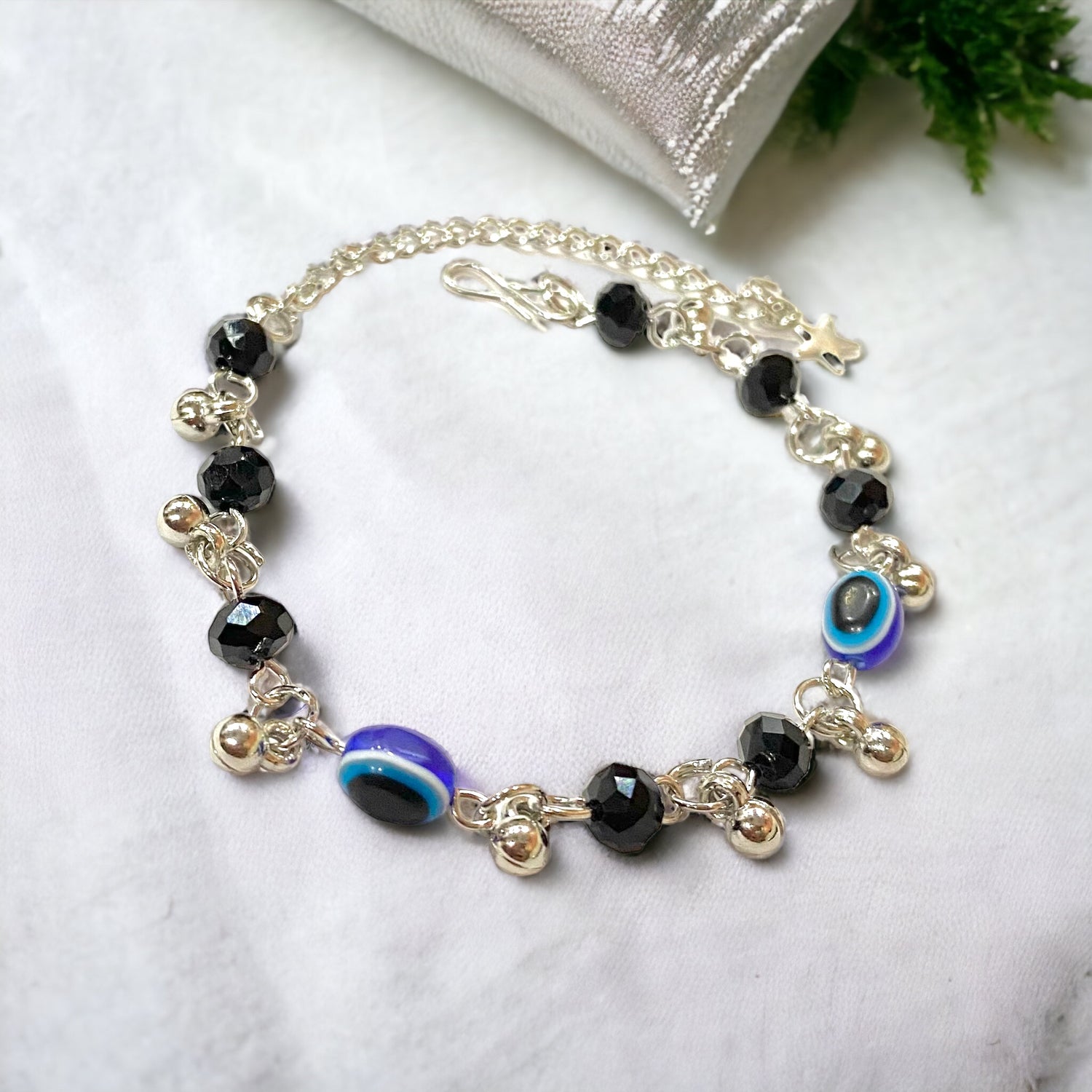 Gray Poseidon Fortune’s Shield Evil Eye bracelet featuring a silver-tone jewelry piece with blue and white evil eye design.
