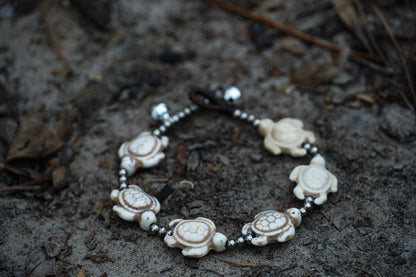 Turquoise sea turtle boho bracelet by Tan Smokey featuring colorful beads and a turtle charm on a woven bracelet band