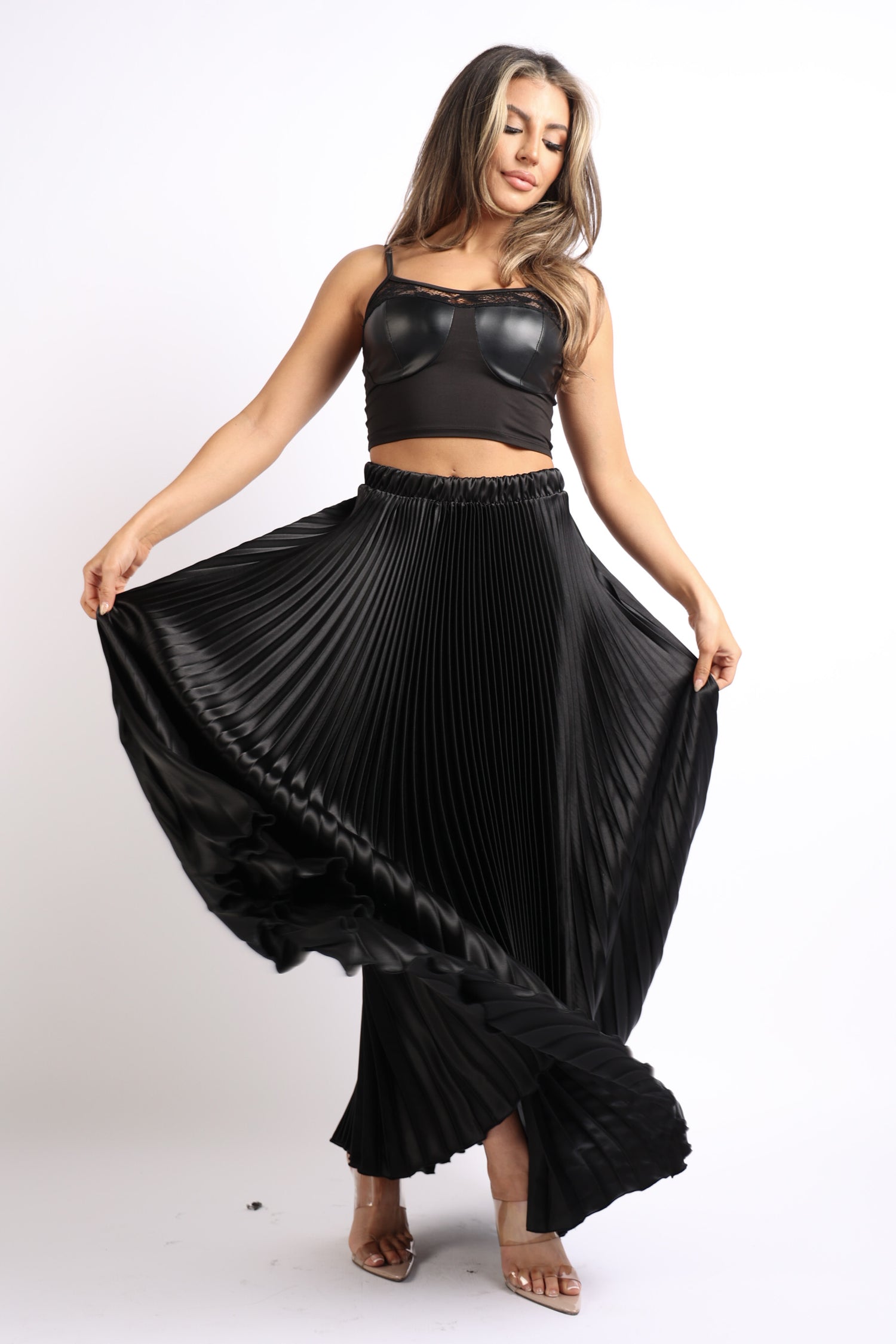 Black satin maxi skirt with elastic high waist and pleated A-line design from Puce Juniper.