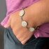Stainless steel bracelet with hymn and scripture glass charms, featuring engraved religious symbols from Orchid Briseis.