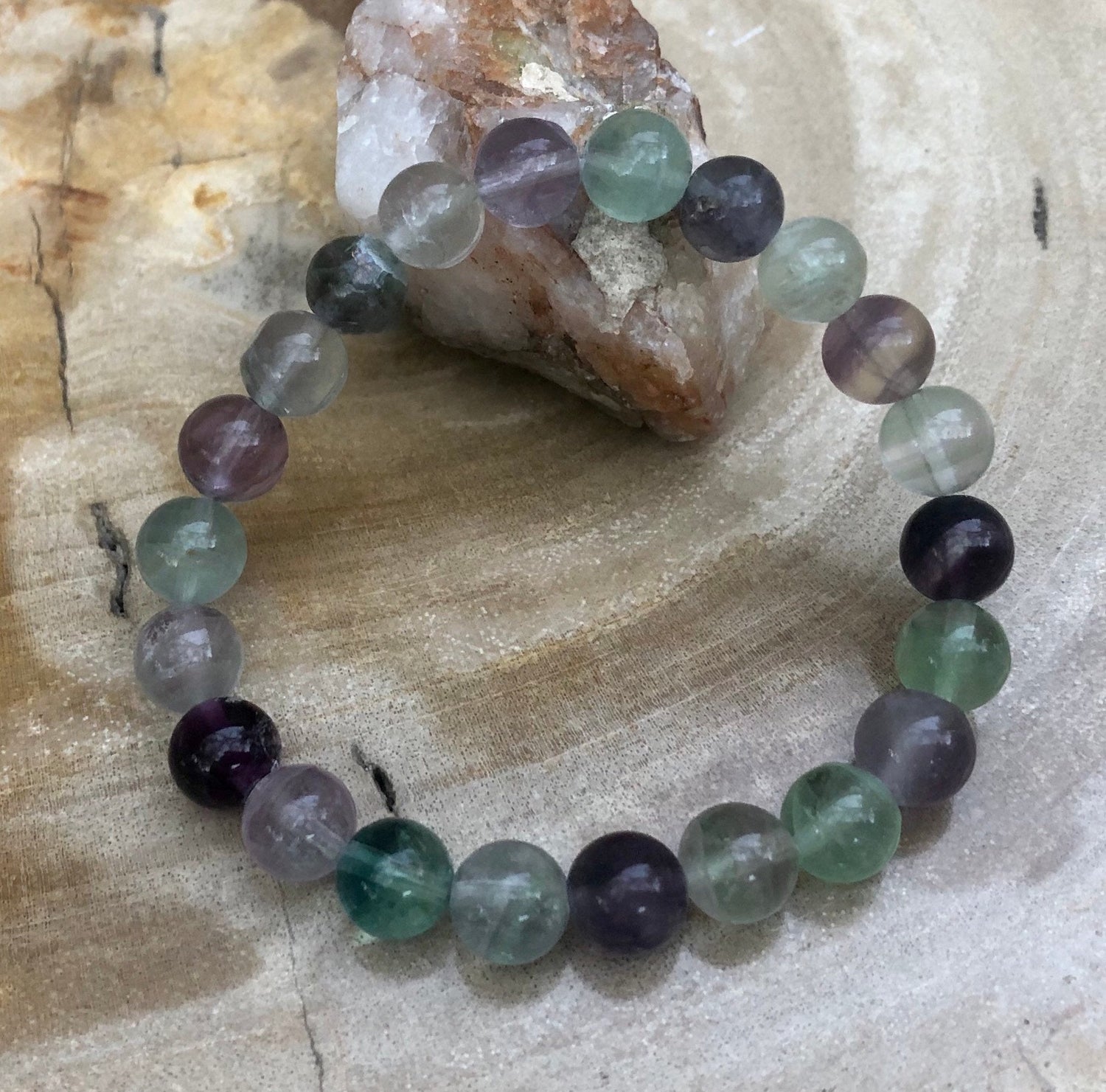 Rainbow fluorite stretch bracelet by Violet Chaos featuring colorful, natural fluorite stones on a flexible elastic band.