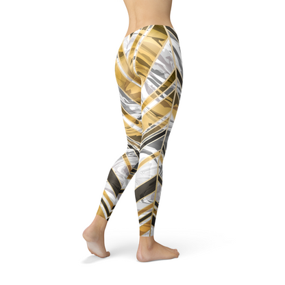 Women’s white marble leggings with black and gold lines from Maroon Sooty, featuring a fitted stretchy design and stylish pattern.