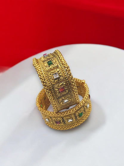 Gold-plated Indian bangle bracelets from Gray Poseidon featuring intricate traditional and modern design details.