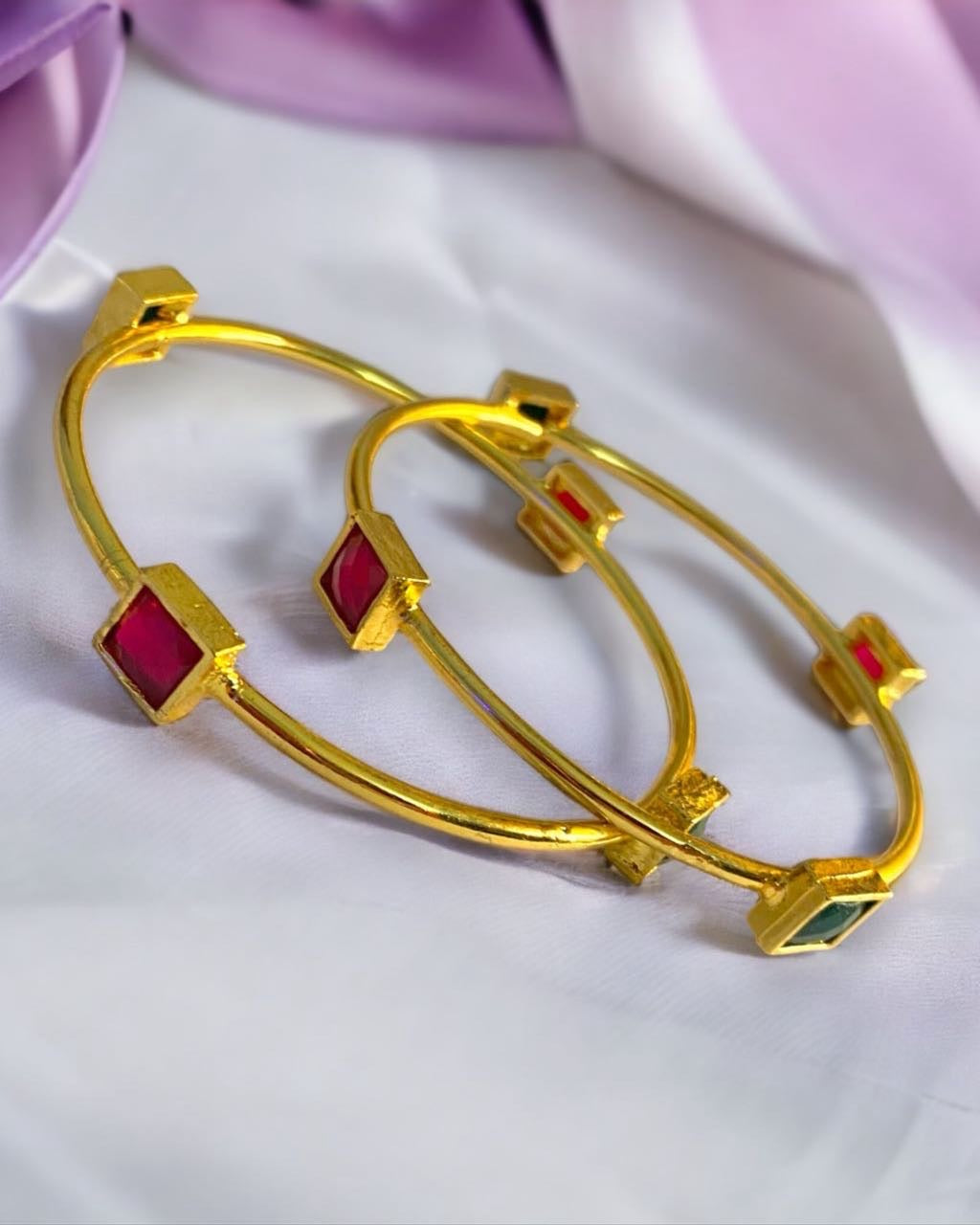 Gold-plated Indian bangles from Gray Poseidon featuring intricate traditional designs and modern jewelry style.