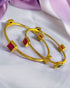 Gold-plated Indian bangles from Gray Poseidon featuring intricate traditional designs and modern jewelry style.
