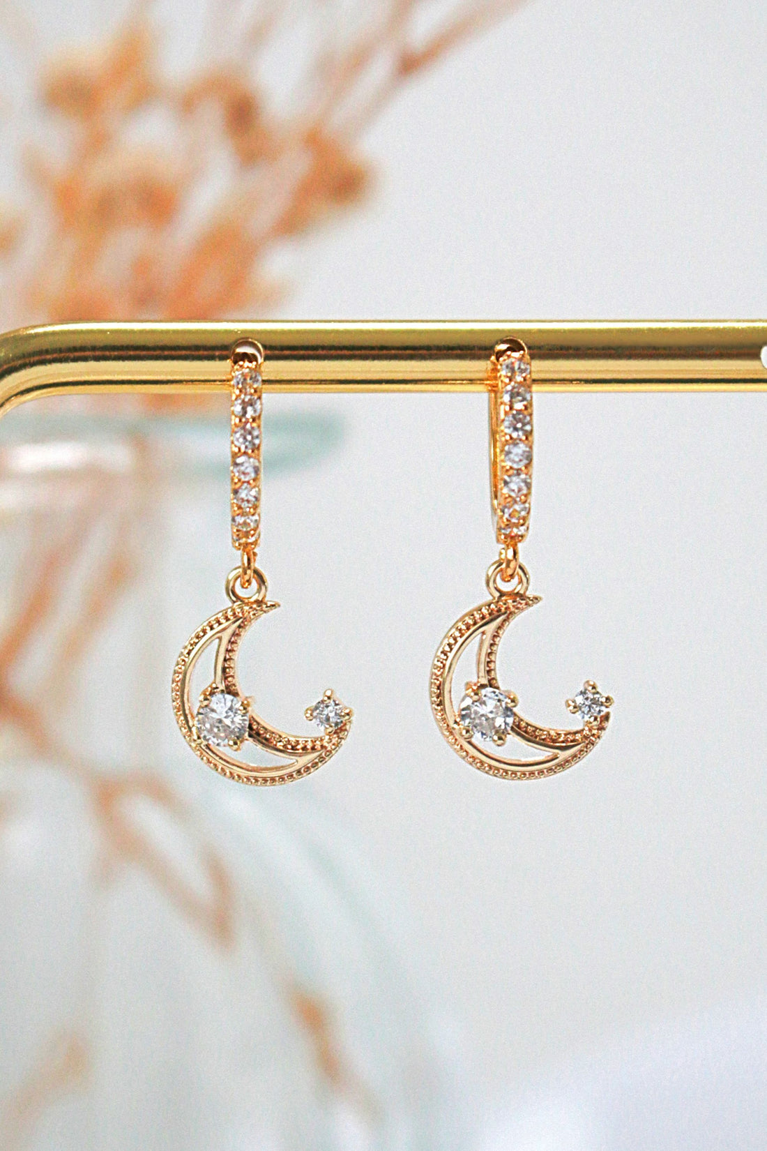Ultramarine Birch 24 Karats Gold Cubic Zirconia Moon Hoop Earrings, shiny gold hoops with sparkling zirconia accents.