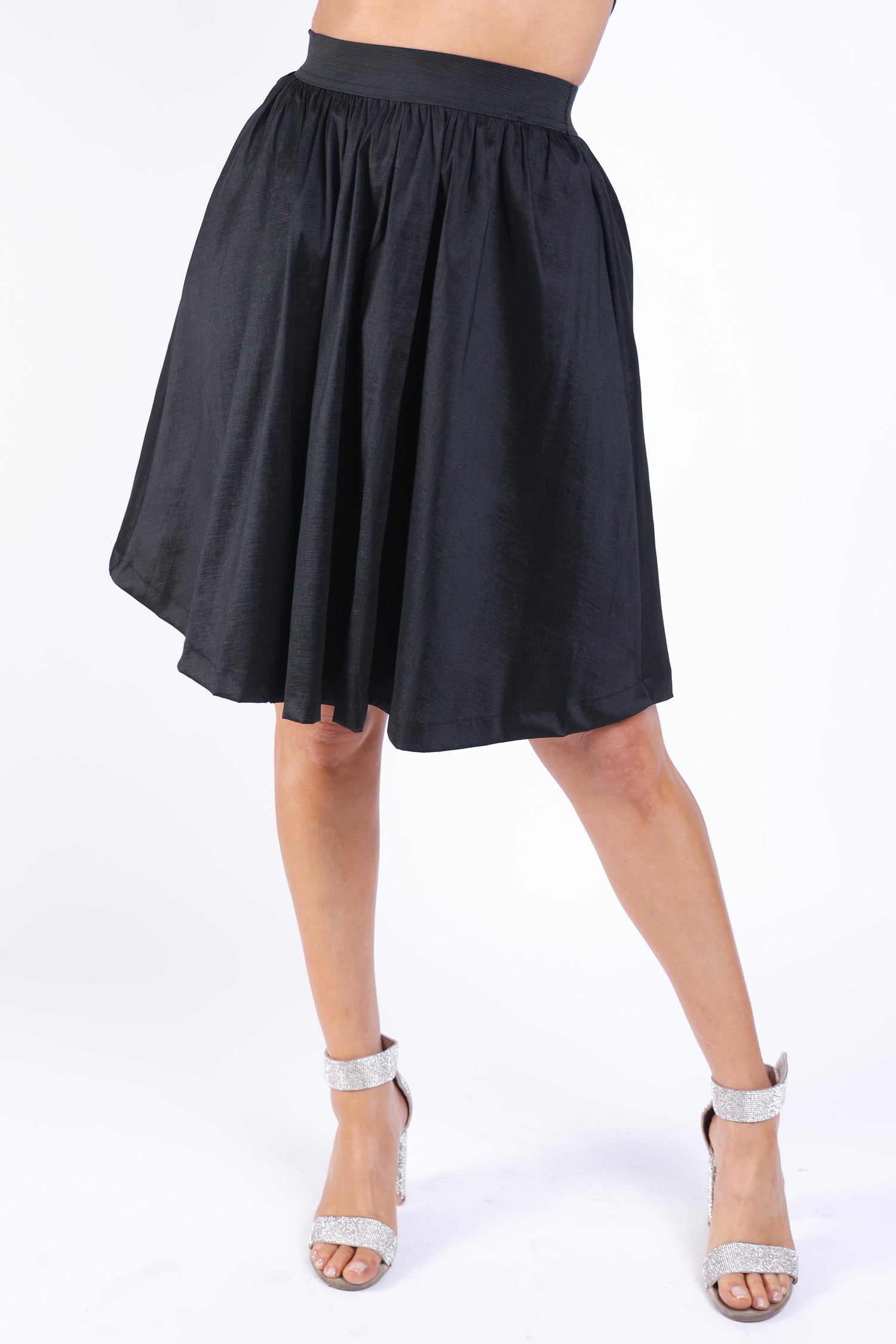 Black pleated midi flare skirt by Puce Juniper featuring a high waist and casual elastic waistband.